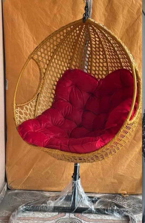 Rattan hanging chair with a red cushion