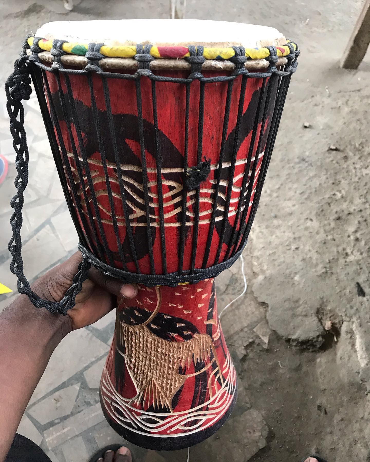 A hand-painted decorative drum with rope detailing