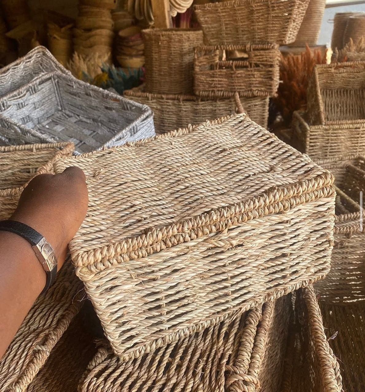 Handwoven natural-fibre storage basket with a fitted lid