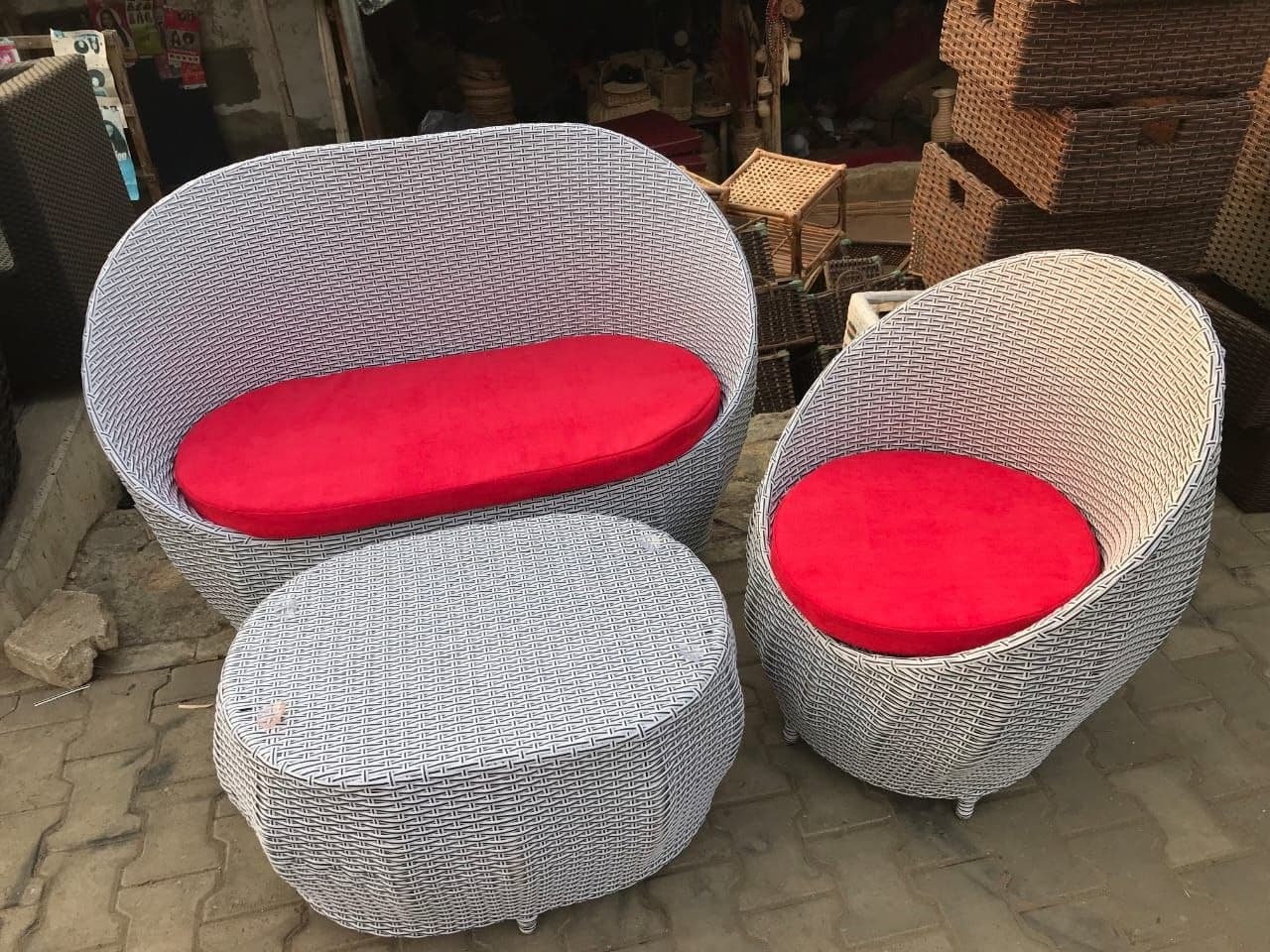 Handwoven rattan lounge chairs with red cushions