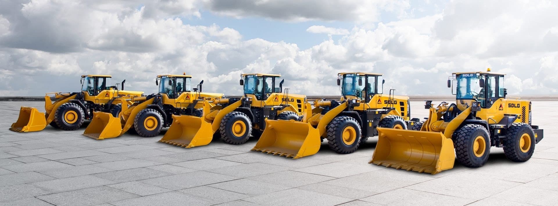 A line of yellow construction wheel loaders